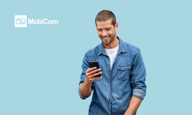 man in shirt smiling with a blue background and mobicom logo