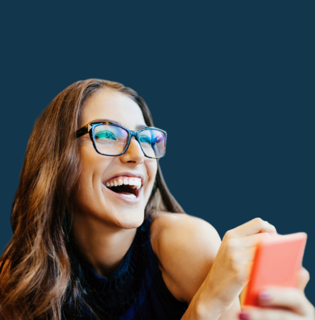 Woman laughing and holding a phone