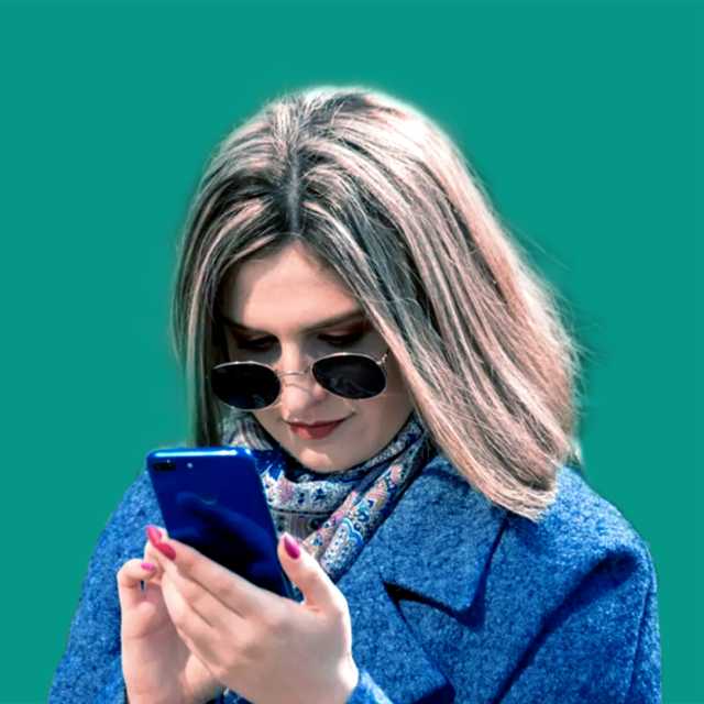 A woman with sunglasses looking at her phone