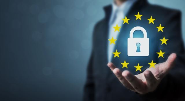 A man in the background, who is 'holding' a GDPR icon in the foreground
