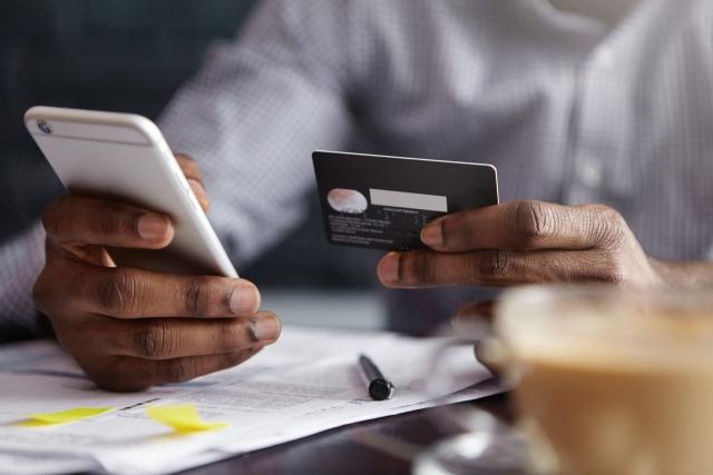 cropped-shot-of-african-american-businessman-paying-with-credit-card-online-scaled