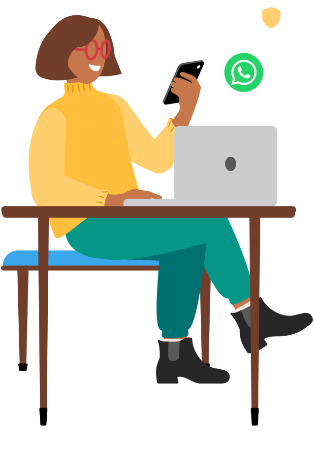 Person looking at phone by computer on WhatsApp